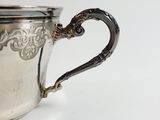 a silver cup that is sitting on a table