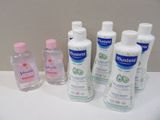 several bottles of hand sanitizer sitting on top of a white counter
