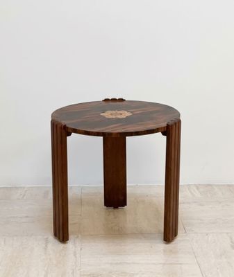 an image of a small wooden table with a flower on it