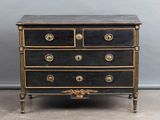 an antique black and gold chest of drawers