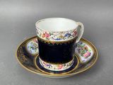 a close up of a cup and saucer on a plate