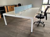 a white desk with a blue divider and a black chair