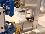 a blue and white pipe and valves in a building