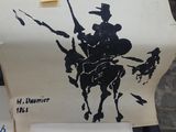 a sign on a table with a drawing of a man on a horse