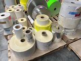 many rolls of paper sitting on a pallet in a warehouse