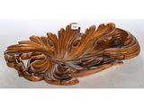 an image of a wooden carving of a peacock on a white background
