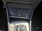 the interior of a car with a gear box and dashboard controls