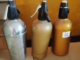 three bottles of liquid sitting next to each other on a table