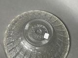 a glass plate with a design on it sitting on a table