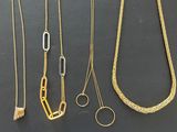 a lot of necklaces that are on display on the table