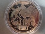 a close up of a coin in a plastic container on a table