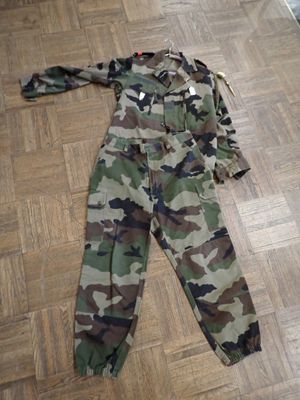 a camouflage suit laying on the floor on the floor