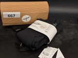 a black umbrella and a brown box on a table