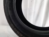 a close up of a tire on a table with a white background