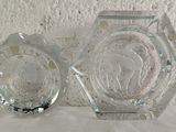 two glass vases sitting next to each other on a table