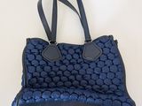 a blue and black handbag with a black handle