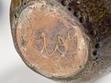 a close up of a vase with a name engraved on it