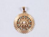 an image of a gold pendant with turquoise stones on a white background