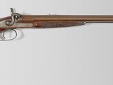 an old gun with a wooden handle on a white background
