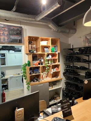 bottles of wine on shelves in a wine shop with a wooden table