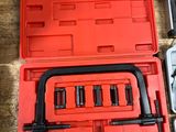 a red case with tools in it on a wooden table