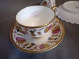 a cup and saucer sitting on a table