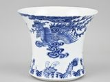 a blue and white vase with a bird on it