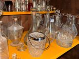 a yellow shelf with a lot of glass items on it