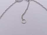 silver plated chain bracelet with a circle charm on a white background