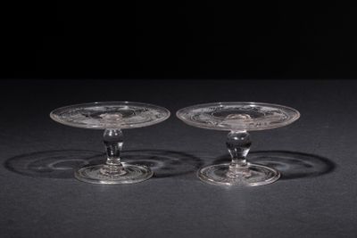 pair of clear glass wine glasses on a black surface