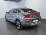 the rear end of a silver suv parked in a garage