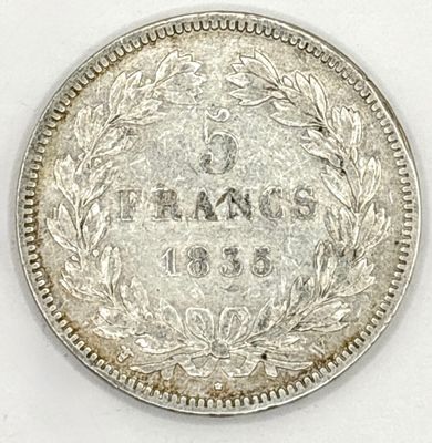 a close up of a coin on a white surface