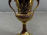 an image of a gold trophy sitting on top of a table