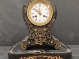 a clock that is sitting on a box on a table