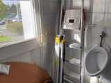 a bathroom with a ladder and a bed in it