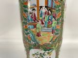 a vase with a painting on it sitting on a table
