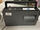 an image of a radio sitting on top of a table next to a remote