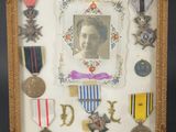 an old picture of a picture of a woman surrounded by medals