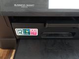 the printer is sitting on top of a wooden table