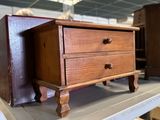a small wooden chest on a shelf in a room