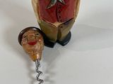 a bottle opener with a wine cork and a bottle opener with a man ' s head