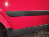 the door handle of a red car with the word motz on it
