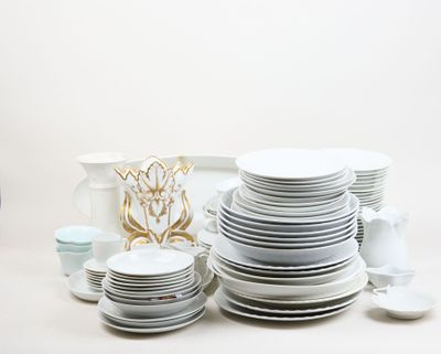 a lot of white plates and cups on the table