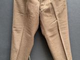 un vieux pantalon suspendu à un cintre accroché au mur