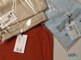 two shirts and a pair of pants on a table