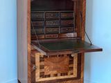 a small desk with a drawer on top of it