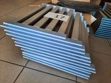 several pieces of metal are stacked on top of each other on a tile floor