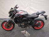 a picture of a motorcycle parked on a black and white checkered floor