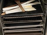 a pan and spatulas in an oven with the door open