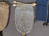 three crocheted bags are lined up on a gray surface